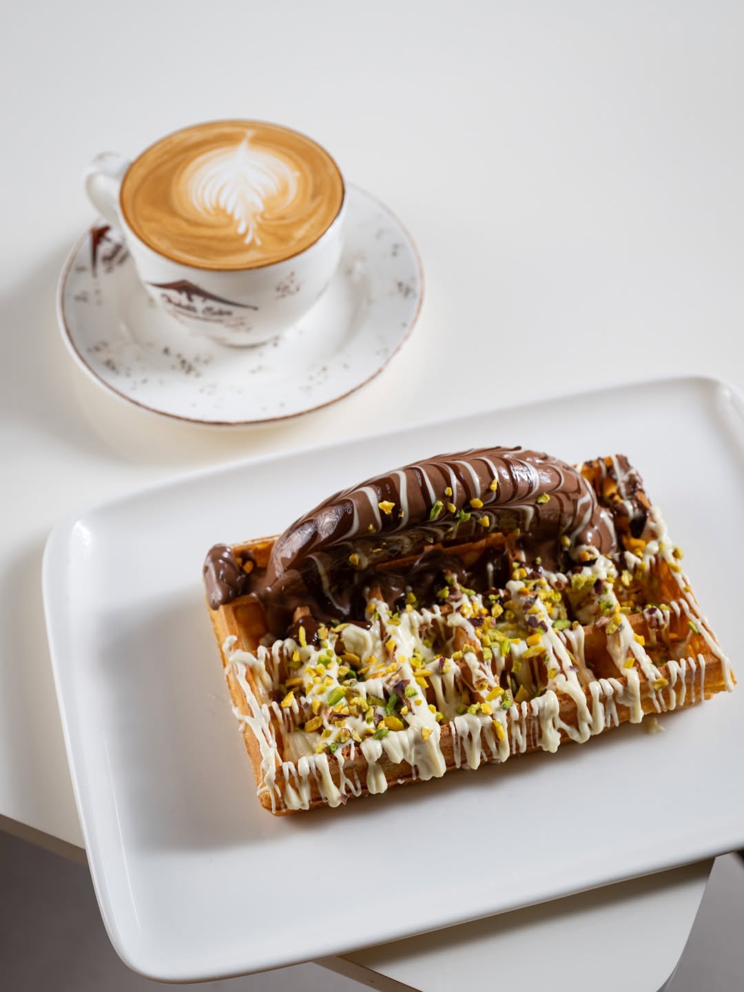 Latte art and Belgian waffle at Myra Chocolate